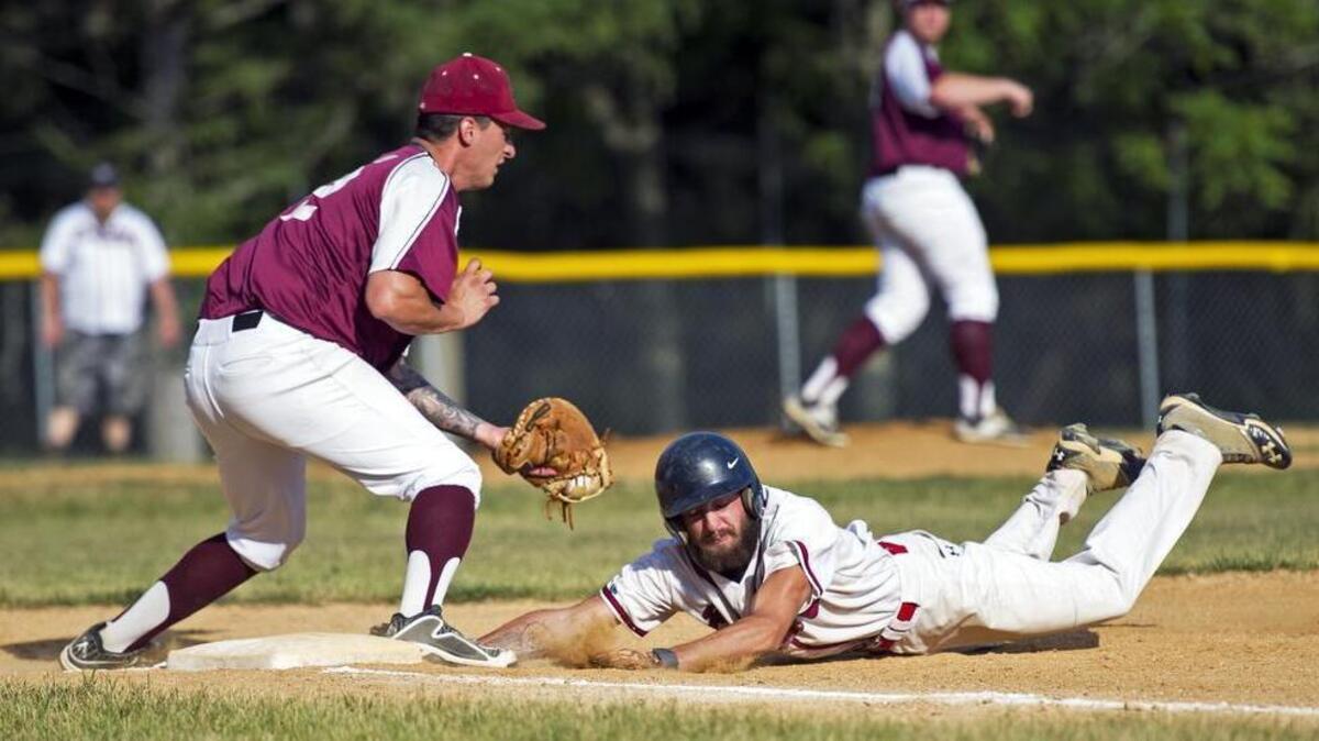 Spring Mills Braves shortstop Cody Luse dives back to first base before Pleasant Gap Peppers first baseman Devin Alterio can place the tag during the Centre County League game at Penns Valley High School on Tuesday, July 12, 2016. Spring Mills won the game 5-4.