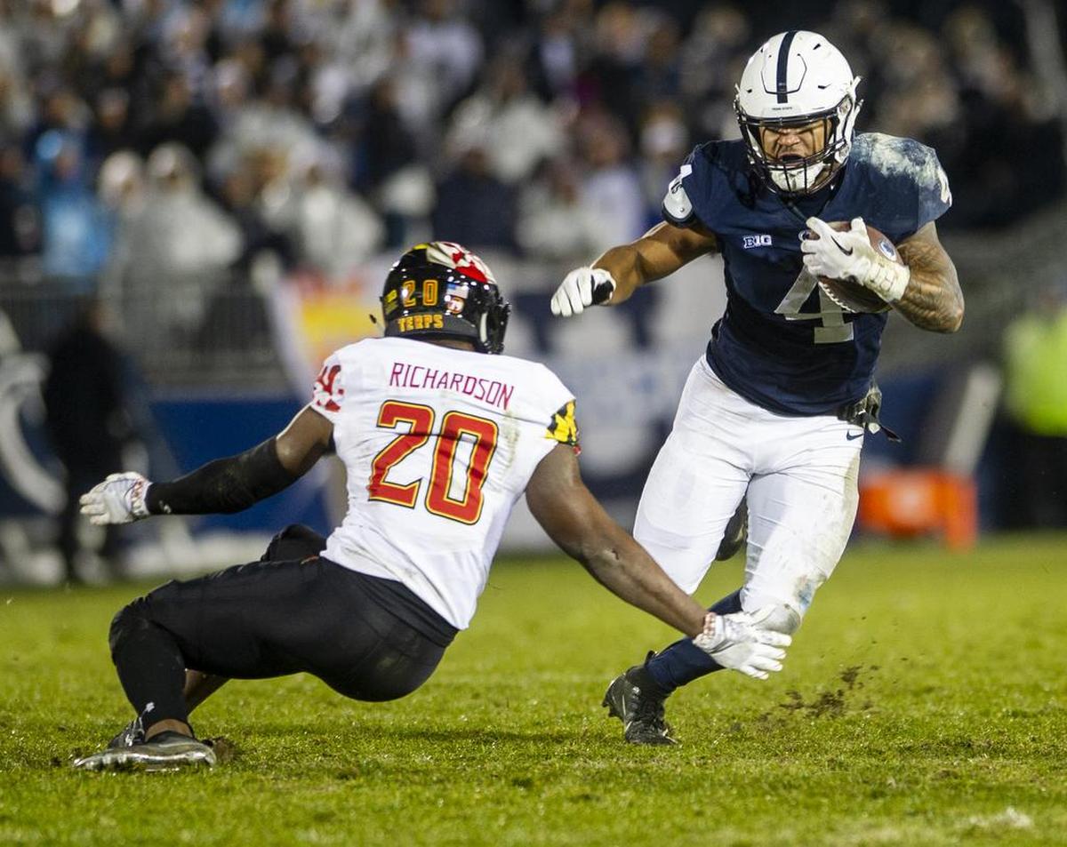 Penn State running back Ricky Slade (4) fakes out Maryland defensive back Antwaine Richardson (20) during the game against Maryland at Beaver Stadium on Saturday, Nov. 24, 2018. No. 12 Penn State won 38-3.