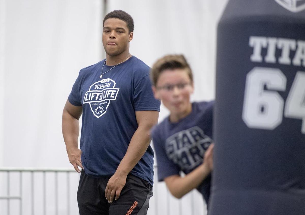 Penn State freshman defensive tackle PJ Mustipher watches as he helps with the kids clinic during the annual Lift For Life at Holuba Hall on Saturday, June 30, 2018.