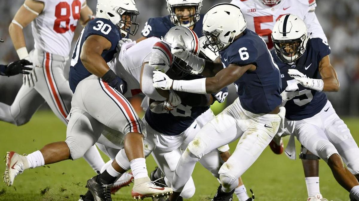 Penn State defensive including Kevin Givens, Shareef Miller and Cam Brown pull down Ohio State’s ball carrier during the game on Saturday, Sept. 29, 2018 at Beaver Stadium.