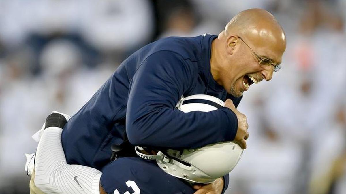 Penn State wide receiver DeAndre Thompkins lifts up coach James Franklin as they warm up for the White Out game against Ohio State on Saturday, Sept. 29, 2018.