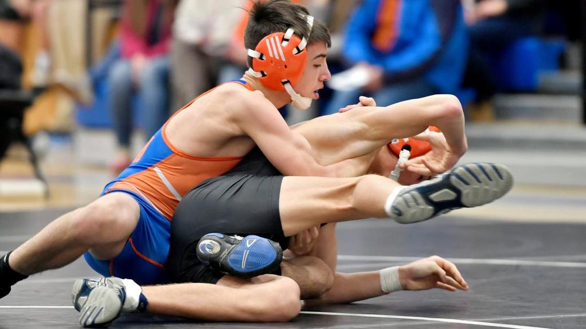 Amonn Ohl, left, of St. Joseph’s Catholic Academy, won all four of his bouts by fall at the Mount Mat Madness tournament in Baltimore.