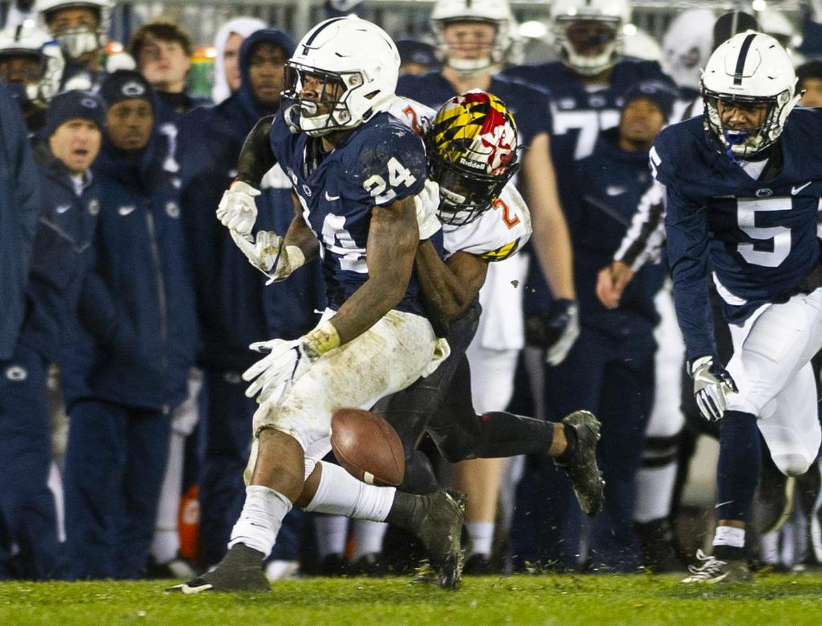 Maryland defensive back RaVon Davis (2) forces Penn State running back Miles Sanders (24) to fumble during the game against Maryland at Beaver Stadium on Saturday, Nov. 24, 2018. No. 12 Penn State won 38-3.