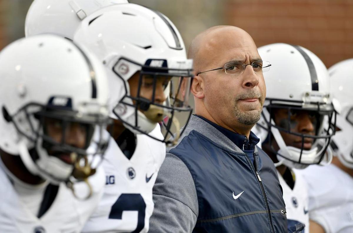 Penn State football coach James Franklin links arms with his players to come out for the game against Maryland at Capital One Field at Maryland Stadium on Saturday, November 25, 2017.
