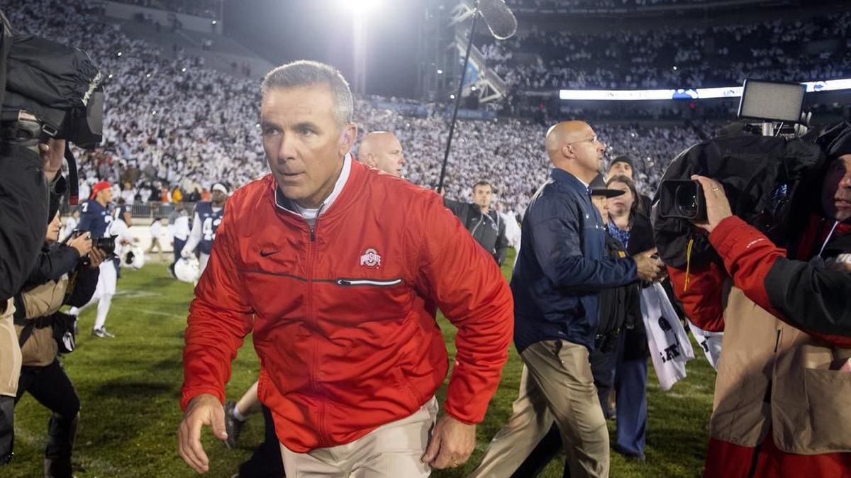 Ohio State coach Urban Meyer runs off the field after shaking hands with Penn State football coach James Franklin after Ohio State lost to Penn State, 24-21 on Saturday, October 22, 2016 at Beaver Stadium.
