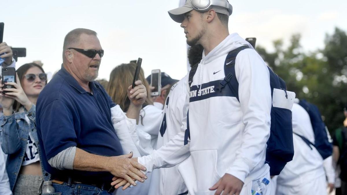 Penn State quarterback Trace McSorley high fives fans as he and the team arrive at Beaver Stadium for the White Out game against Ohio State on Saturday, Sept. 29, 2018.