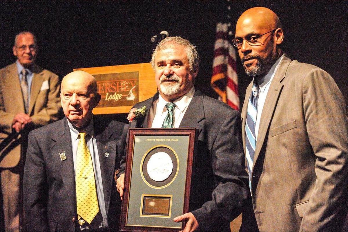 Paul Packer, center, was inducted in May 2017 into the Class of 2017 PA Chapter of the National Wrestling Hall of Fame. Distinguished members of the HOF making the presentation of Packer’s plaque include John Reese (left) and Carlton Haselrig.